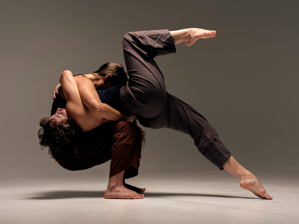 push/FOLD dancers Alana Rae and Marina Vianello pose in a partnered backwards arch with one leg extended elegantly at Cobalt Studios in Portland, Oregon | Photography: Samuel Hobbs