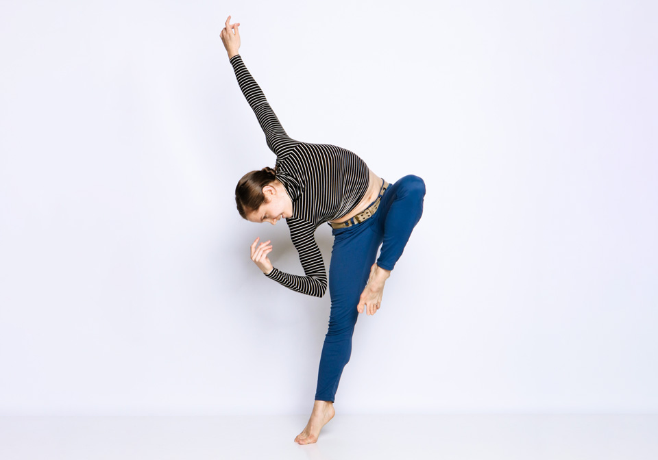push/FOLD dancer Holly Shaw posed in a passé position with her leg while flexed in a sidebend and her arm extended elegantly.