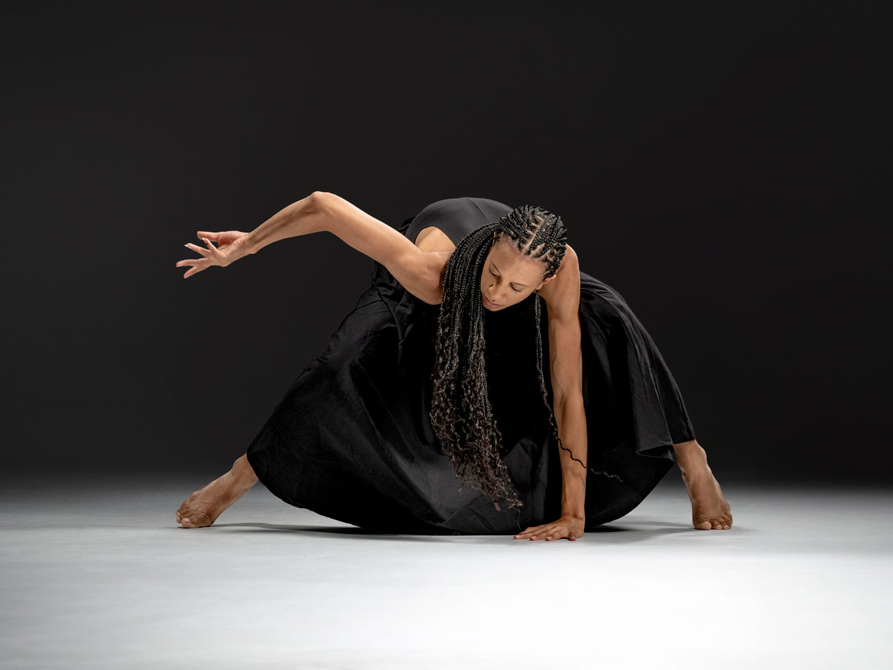 push/FOLD dancer Ashley Morton creating a shapely pose in a black dress at Cobalt Studios in Portland, Oregon | Photography: Samuel Hobbs