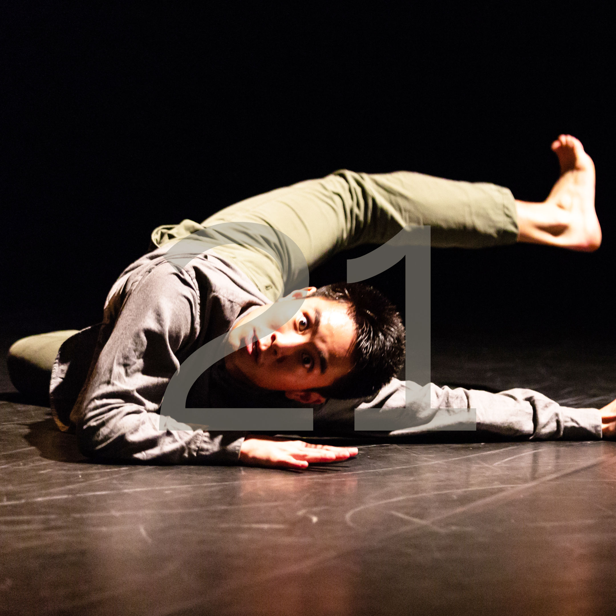 Union PDX - Festival:21 artist Tom Tsai performs his work 'A Place to Call Home' with a mix of break-dance and contemporary movement at the Hampton Opera Center in Portland, Oregon. The number 21 overlays the image to indicate the festival year. | Photography: Kuang Jingkai